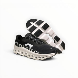FWSports Shoes On Cloudmonster men's running shoes in black and white with breathable mesh and thick CloudTec cushioning.