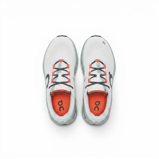FWSports Shoes On Cloudmonster women's running shoes in white with wave blue accents and orange interior details.