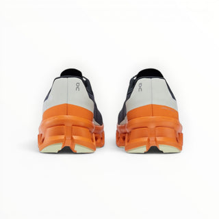 FWSports Shoes ON Cloudmonster men's running shoes in turmeric orange with thick CloudTec cushioning, rear view.