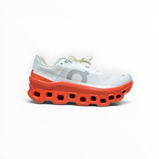 FWSports Shoes On Cloudmonster men's running shoe in white mesh with an oversized orange red CloudTec foam sole.