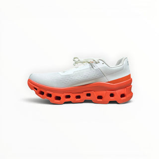 FWSports Shoes On Cloudmonster men's running shoe in white mesh with an oversized orange red CloudTec sole.