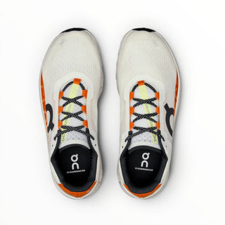 FWSports Shoes On Cloudmonster women's running shoes in white and orange with breathable mesh and cushioned soles.
