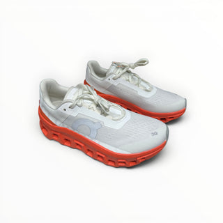 FWSports Shoes On Cloudmonster women's running shoes in white and orange red with oversized CloudTec cushioning.