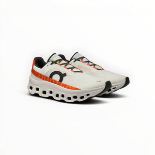 FWSports Shoes On Cloudmonster women's running shoes in white and orange with breathable mesh and thick CloudTec sole.