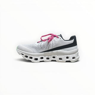 FWSports Shoes On Cloudmonster men's running shoe in white with black accents and bright pink laces, side view.
