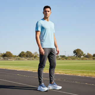 FWSports Shoes model wearing white and dark blue On Cloudtilt sneakers with mesh upper on a running track