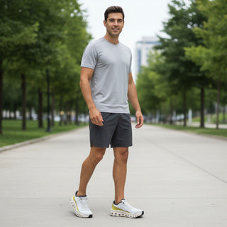 FWSports Shoes model wearing beige and yellow On Running Cloudmonster sneakers with a grey t-shirt and dark shorts