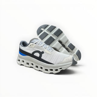 FWSports Shoes On Running Cloudmonster Void sneakers in white and gray with blue accents and signature CloudTec sole.