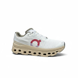 FWSports Shoes women's On Running Cloudmonster running shoe in white mesh with gold sole and pink logo detail.