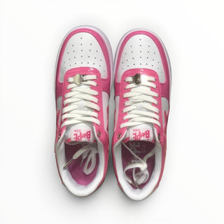 FWSports Shoes BAPE STA low-top sneakers in pink and white with lace-up closure and cushioned footbed.