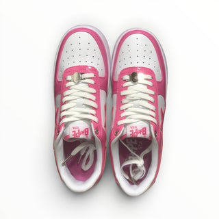FWSports Shoes BAPE STA low-top sneakers in pink and white with a lace-up closure and signature side star design.