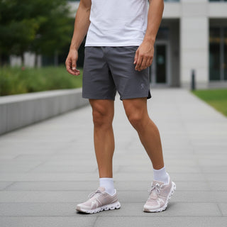 FWSports Shoes On Cloud 6 Waterproof sneakers in purple worn by a man with grey shorts on a paved outdoor walkway