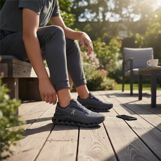 FWSports Shoes Womens On-Run Cloudtilt in black and blue mesh with Helion superfoam cushioning on a wooden deck