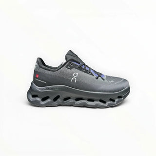 FWSports Shoes Womens On-Run Cloudtilt in black and blue with breathable mesh upper and cushioned rocker sole.